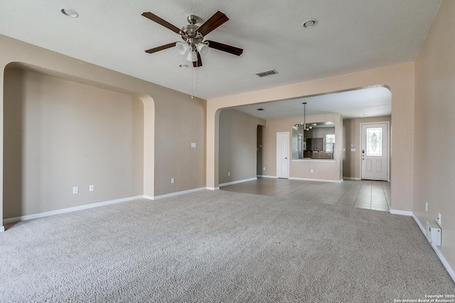 1023 Sundance Fall, San Antonio, TX 78245 - unfurnished living room featuring ceiling fan, carpet, arched walkways, and baseboards