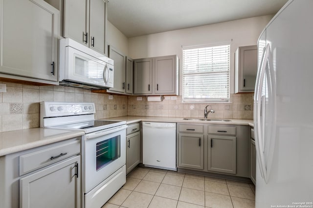1023 Sundance Fall, San Antonio, TX 78245 - kitchen featuring white appliances, a sink, light tile patterned floors, and light countertops