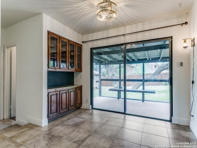 2922 Low Oak St, San Antonio, TX 78232 - unfurnished dining area featuring baseboards, a chandelier, and light tile patterned floors