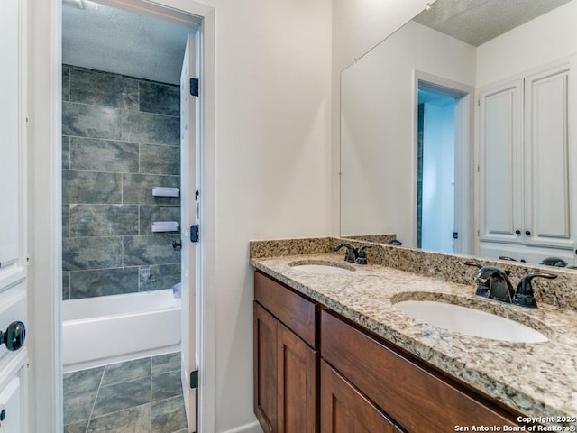 2922 Low Oak St, San Antonio, TX 78232 - bathroom featuring double vanity, a textured ceiling, and bathtub / shower combination