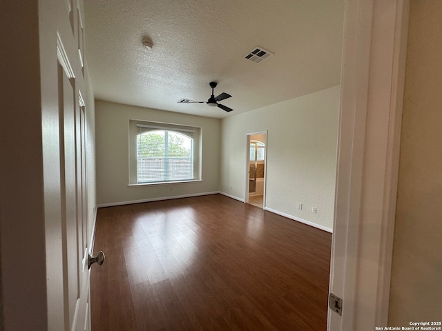 520 Ginsberg, Schertz, TX 78154 - empty room with dark wood-style flooring, ceiling fan, baseboards, and a textured ceiling