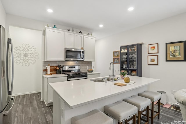 158 Canopy Oak, New Braunfels, TX 78130 - kitchen with stainless steel appliances, a sink, backsplash, a kitchen breakfast bar, and recessed lighting