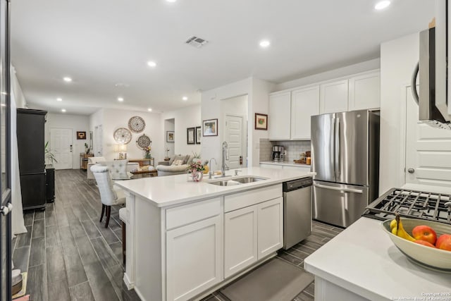 158 Canopy Oak, New Braunfels, TX 78130 - kitchen with appliances with stainless steel finishes, a sink, open floor plan, white cabinets, and light countertops