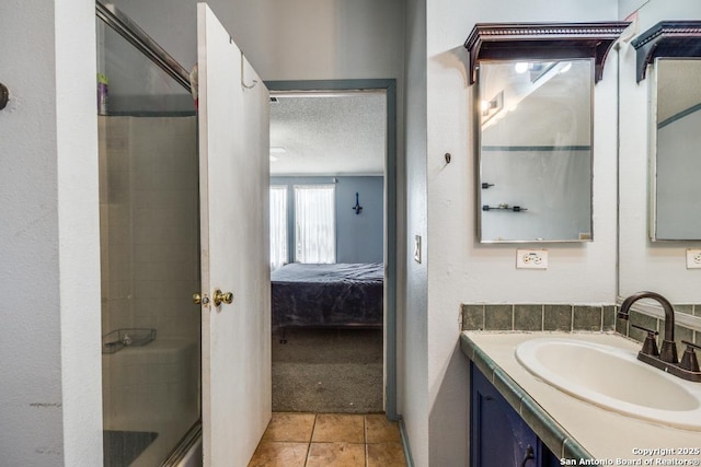 22337 Red Sand, San Antonio, TX 78264 - full bathroom with ensuite bath, vanity, a shower with door, tile patterned flooring, and a textured ceiling
