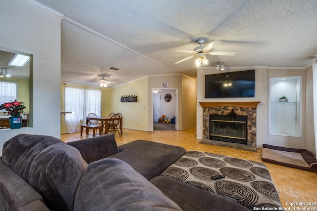 22337 Red Sand, San Antonio, TX 78264 - living room featuring a ceiling fan, ornamental molding, a fireplace, and a textured ceiling