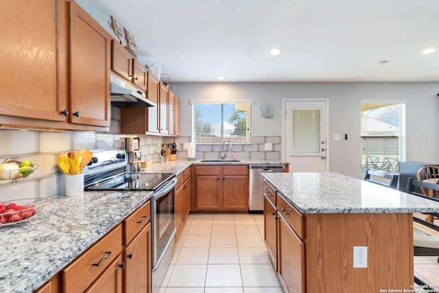 11807 Amber Tree, San Antonio, TX 78254 - kitchen with appliances with stainless steel finishes, under cabinet range hood, a sink, brown cabinets, and recessed lighting