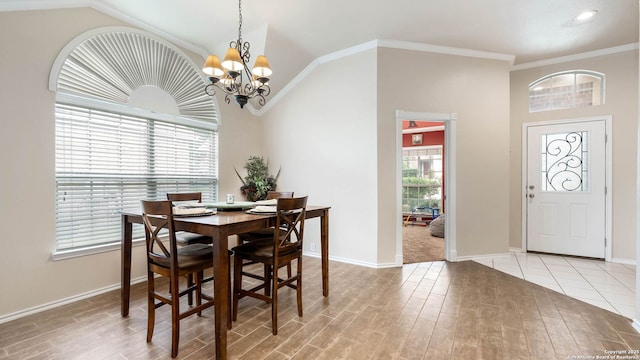 21627 Rio Comal, San Antonio, TX 78259 - dining area with wood finished floors, a chandelier, baseboards, vaulted ceiling, and crown molding