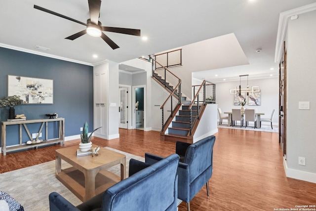 3902 Creek Pt, San Antonio, TX 78230 - living room with wood finished floors, ceiling fan, stairway, baseboards, and crown molding