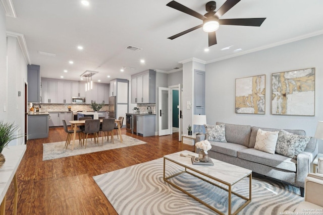 3902 Creek Pt, San Antonio, TX 78230 - living room with ornamental molding, recessed lighting, ceiling fan, beverage cooler, and dark wood-style floors