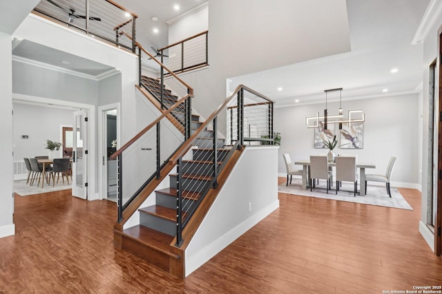 3902 Creek Pt, San Antonio, TX 78230 - stairway featuring crown molding, wood finished floors, baseboards, a high ceiling, and recessed lighting