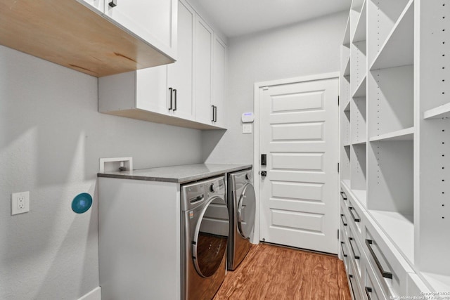 3902 Creek Pt, San Antonio, TX 78230 - laundry area featuring light wood-style flooring, independent washer and dryer, and cabinet space
