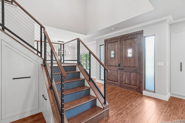 3902 Creek Pt, San Antonio, TX 78230 - entrance foyer featuring crown molding, stairway, wood finished floors, and baseboards