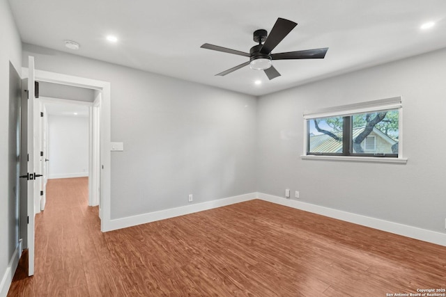 3902 Creek Pt, San Antonio, TX 78230 - empty room with wood finished floors, a ceiling fan, baseboards, recessed lighting, and a smoke detector