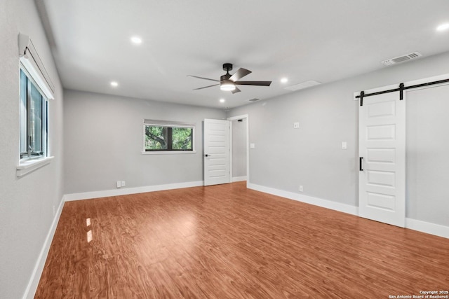 3902 Creek Pt, San Antonio, TX 78230 - empty room featuring a barn door, a ceiling fan, wood finished floors, recessed lighting, and baseboards