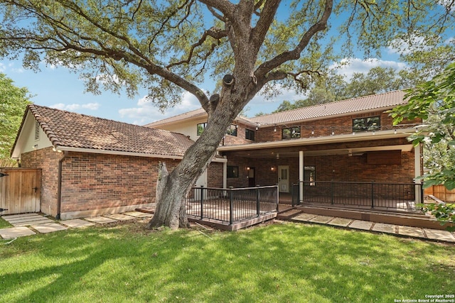 3902 Creek Pt, San Antonio, TX 78230 - rear view of house with brick siding, a tile roof, and a lawn
