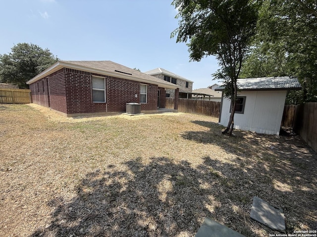 4742 Highland Farm, San Antonio, TX 78244 - rear view of property featuring brick siding, an outdoor structure, and central AC