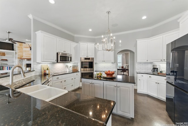 810 Pinnacle, New Braunfels, TX 78132 - kitchen with black appliances, a sink, arched walkways, finished concrete floors, and backsplash