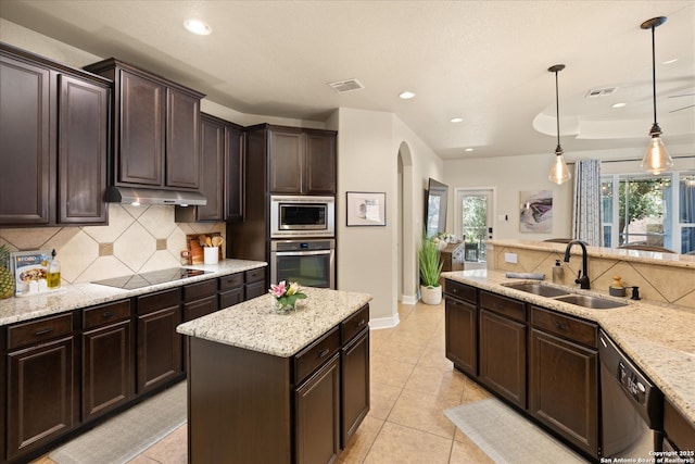 13055 Grove Pt, San Antonio, TX 78253 - kitchen featuring appliances with stainless steel finishes, a sink, arched walkways, recessed lighting, and decorative backsplash