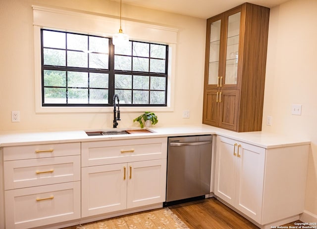 482 S Edwards, Charlotte, TX 78011 - kitchen with stainless steel dishwasher, a sink, glass insert cabinets, white cabinetry, and light countertops