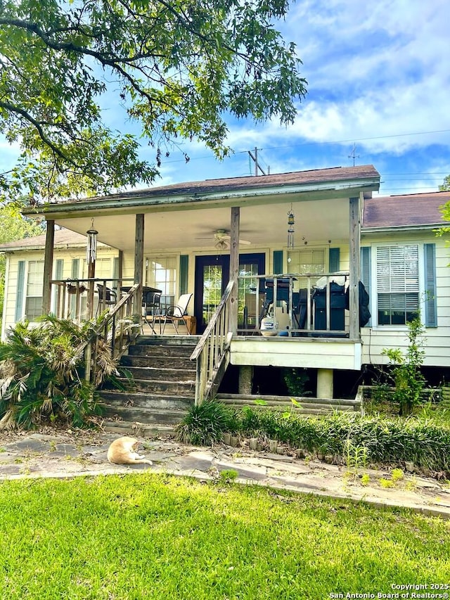 129 W High Line, Trinity, TX 75862 - rear view of house with a porch, a yard, and stairway