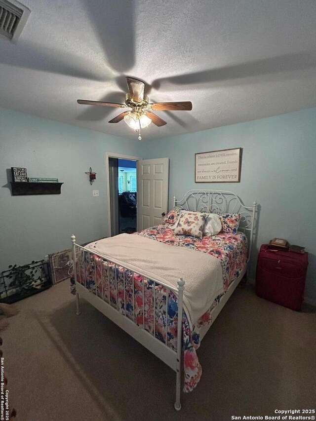 129 W High Line, Trinity, TX 75862 - carpeted bedroom featuring a ceiling fan and a textured ceiling