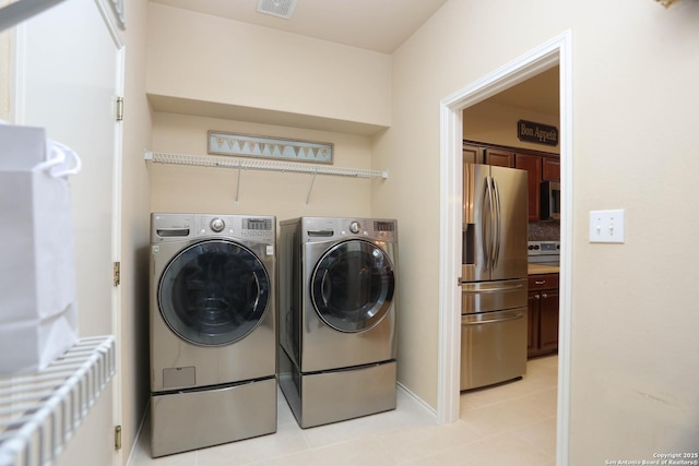 17206 Ashbury, San Antonio, TX 78247 - laundry room with separate washer and dryer, radiator heating unit, light tile patterned floors, and baseboards
