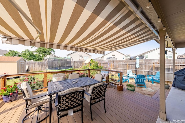 5483 Jasmine, Bulverde, TX 78163 - wooden terrace featuring outdoor dining space, a fenced backyard, and a trampoline