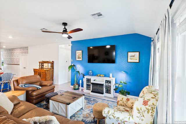 5483 Jasmine, Bulverde, TX 78163 - living area featuring lofted ceiling, a ceiling fan, baseboards, wood finished floors, and an accent wall