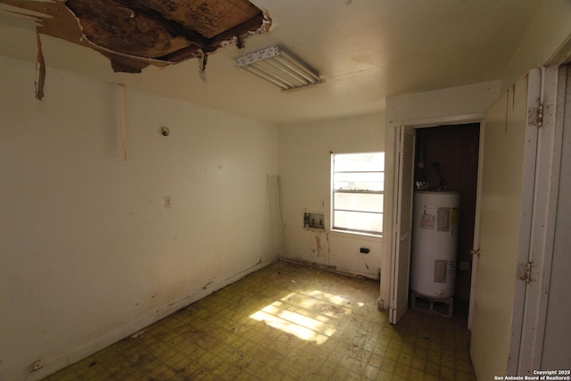 1413 Martin, Pleasanton, TX 78064 - empty room with electric water heater and light flooring
