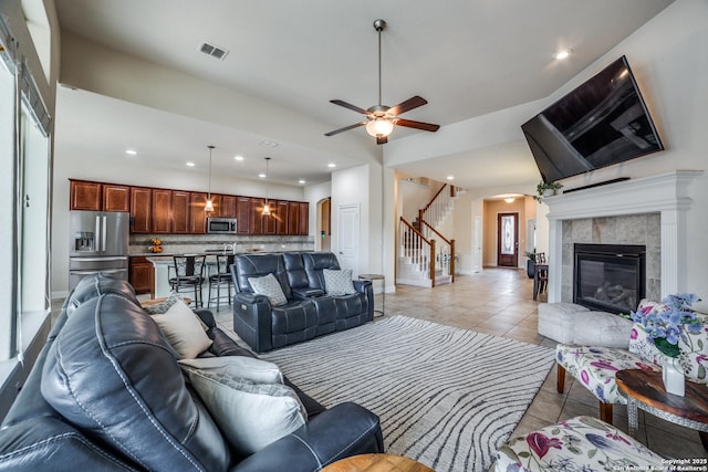 2023 Wilby Ln, San Antonio, TX 78253 - living room with stairs, baseboards, a tile fireplace, arched walkways, and light tile patterned floors