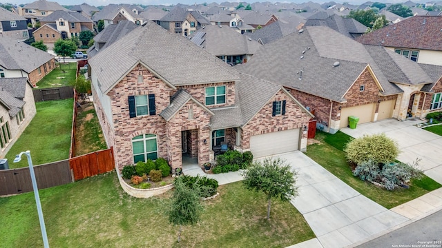 2023 Wilby Ln, San Antonio, TX 78253 - traditional-style house featuring driveway, a residential view, brick siding, an attached garage, and roof with shingles