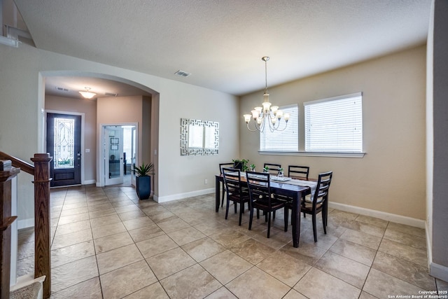 2023 Wilby Ln, San Antonio, TX 78253 - dining area featuring arched walkways, light tile patterned flooring, a chandelier, and baseboards