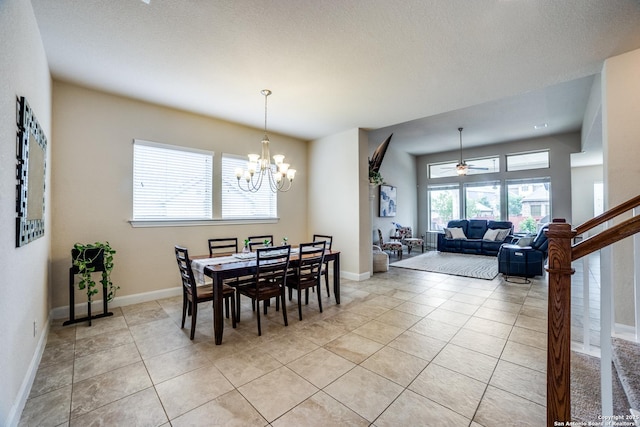 2023 Wilby Ln, San Antonio, TX 78253 - dining room featuring light tile patterned flooring, a chandelier, a ceiling fan, and baseboards