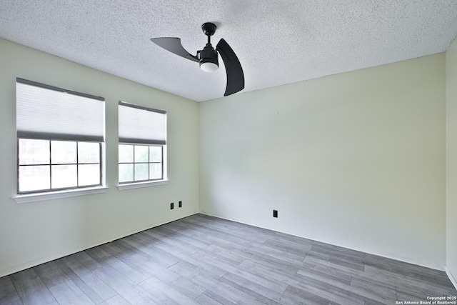 6100 Woodlake Pkwy Unit 706, San Antonio, TX 78244 - spare room featuring ceiling fan, wood finished floors, and a textured ceiling