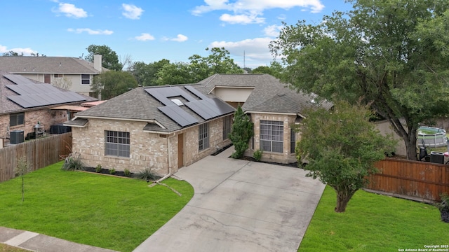 4303 Lakebend W, San Antonio, TX 78244 - view of front of home featuring roof with shingles, brick siding, solar panels, and central air condition unit