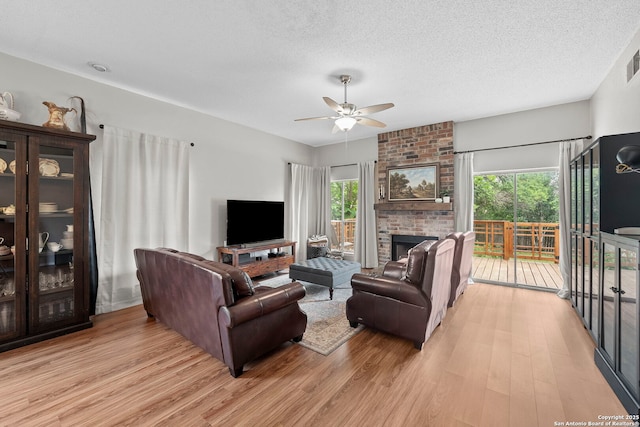 4303 Lakebend W, San Antonio, TX 78244 - living room featuring a ceiling fan, light wood finished floors, plenty of natural light, and a textured ceiling