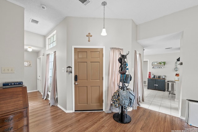 4303 Lakebend W, San Antonio, TX 78244 - foyer entrance featuring light wood-style floors, vaulted ceiling, and baseboards