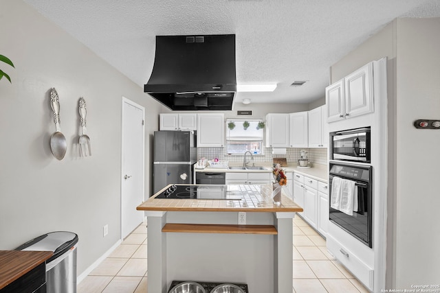4303 Lakebend W, San Antonio, TX 78244 - kitchen featuring black appliances, extractor fan, a sink, light tile patterned floors, and white cabinets