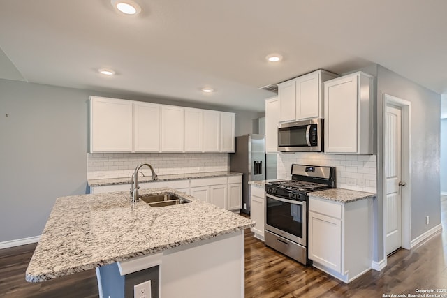 4823 Swing Arc, San Antonio, TX 78261 - kitchen with stainless steel appliances, a sink, baseboards, light stone countertops, and dark wood finished floors
