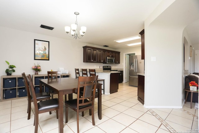 9011 Twincreek Farm, Converse, TX 78109 - dining room featuring arched walkways, a chandelier, light tile patterned floors, and baseboards