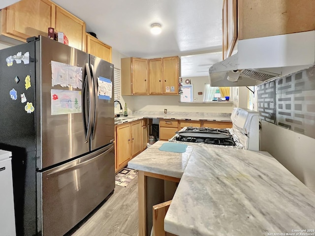 410 W Dickson, San Antonio, TX 78214 - kitchen featuring freestanding refrigerator, white gas range oven, light brown cabinets, under cabinet range hood, and light wood-type flooring
