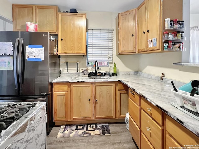 410 W Dickson, San Antonio, TX 78214 - kitchen with a sink, light brown cabinets, freestanding refrigerator, and light wood-type flooring