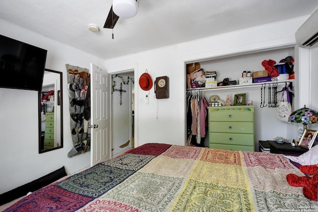 820 Kunkel, Seguin, TX 78155 - bedroom featuring a wall unit AC, a closet, and a ceiling fan