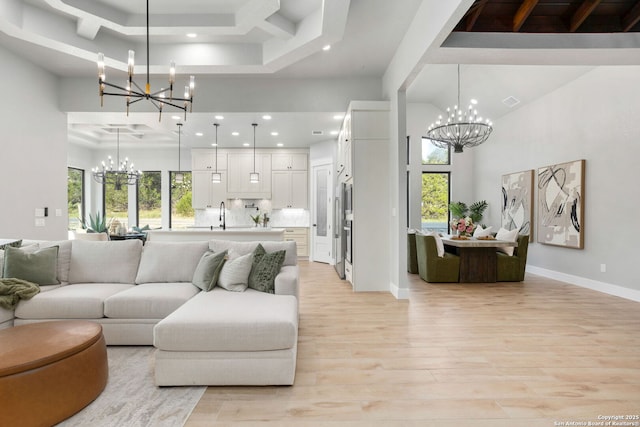 1475 Echo Mdw, Spring Branch, TX 78070 - living area with a chandelier, light wood-style flooring, a high ceiling, recessed lighting, and healthy amount of natural light