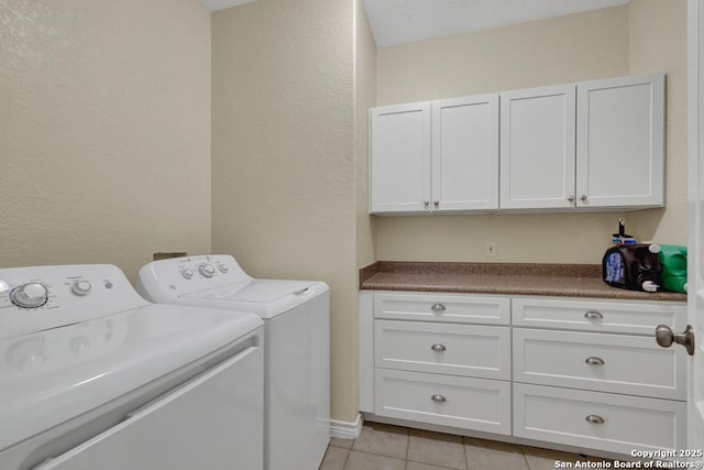 141 Rio Grande, Seguin, TX 78155 - laundry area with cabinet space, washing machine and dryer, light tile patterned flooring, and a textured wall