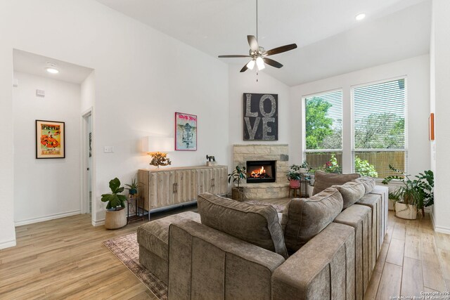 9730 Kremmen, Boerne, TX 78006 - living area featuring light wood finished floors, a ceiling fan, baseboards, vaulted ceiling, and a fireplace