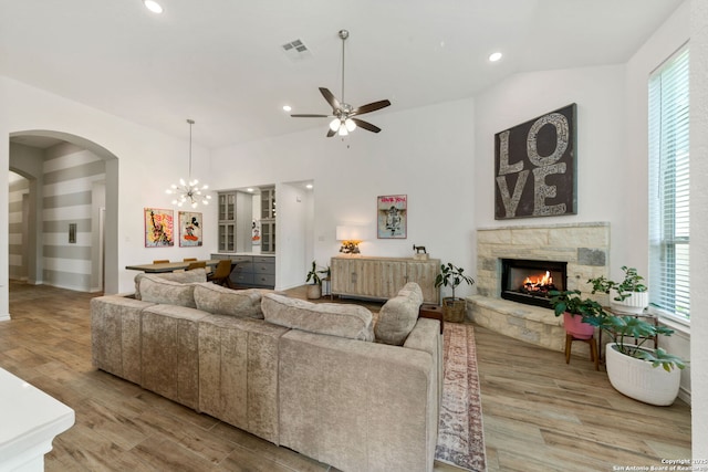 9730 Kremmen, Boerne, TX 78006 - living area featuring light wood finished floors, ceiling fan, a fireplace, arched walkways, and recessed lighting