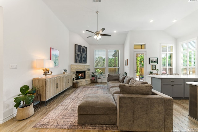 9730 Kremmen, Boerne, TX 78006 - living area with vaulted ceiling, ceiling fan, light wood finished floors, a stone fireplace, and recessed lighting
