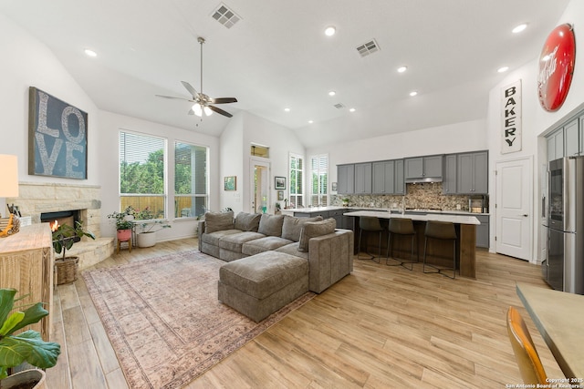 9730 Kremmen, Boerne, TX 78006 - living room featuring ceiling fan, plenty of natural light, light wood-style flooring, a stone fireplace, and recessed lighting