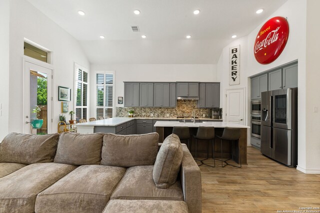 9730 Kremmen, Boerne, TX 78006 - living room with light wood finished floors, recessed lighting, and high vaulted ceiling